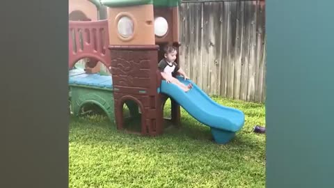 Funny babies playing slide