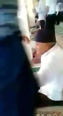 Man chanting slogans in a mosque