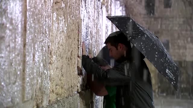 Snow covers Jerusalem as a storm hits the region