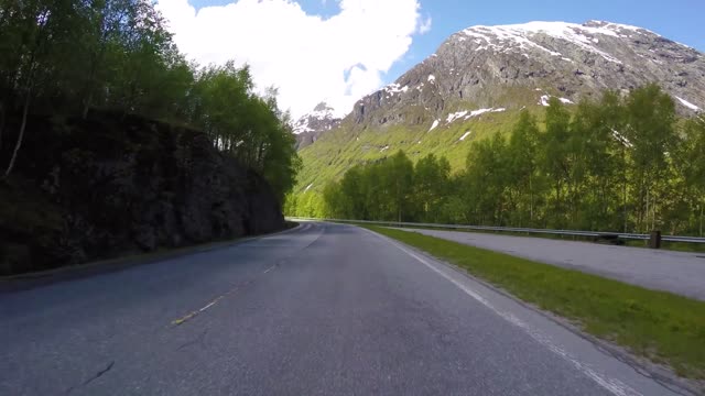 driving a car on a serpentine road in norway