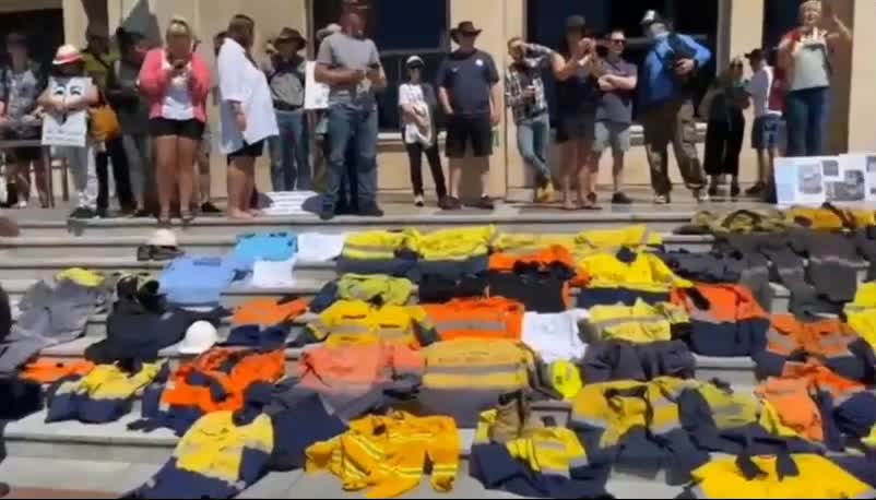 Australians laying work uniform on steps of parliament