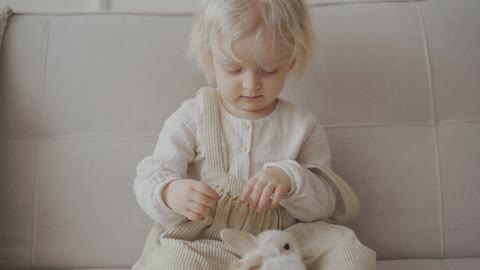 A Child Playing with a Bunny