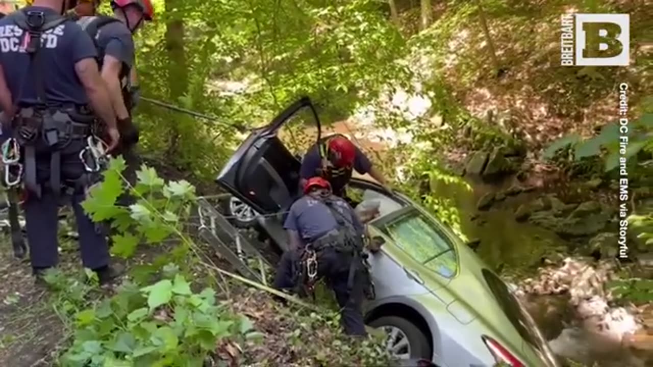 Rescue Crew Extracts Woman from Car Teetering over Creek