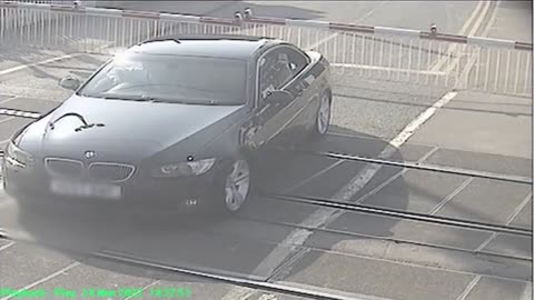 Driver gets stuck on level crossing as a speeding train approaches