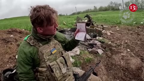 Ukrainian fighters display the killed Russians and the captured weapons near Bakhmut