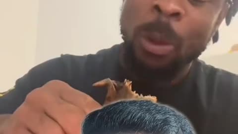 Man eats whole chicken like it's nothing and it's finger licking good