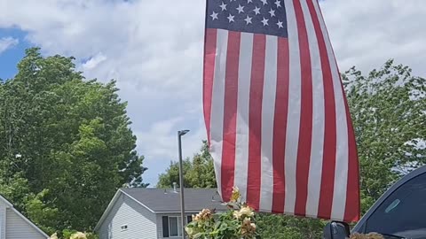 A peaceful afternoon on the front porch, with the Stars and Stripes blowing in the wind.