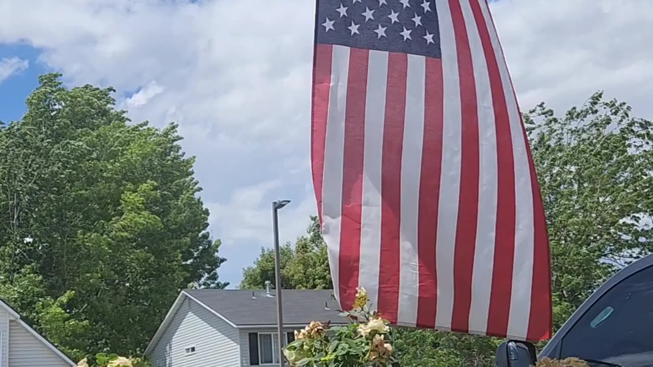 A peaceful afternoon on the front porch, with the Stars and Stripes blowing in the wind.