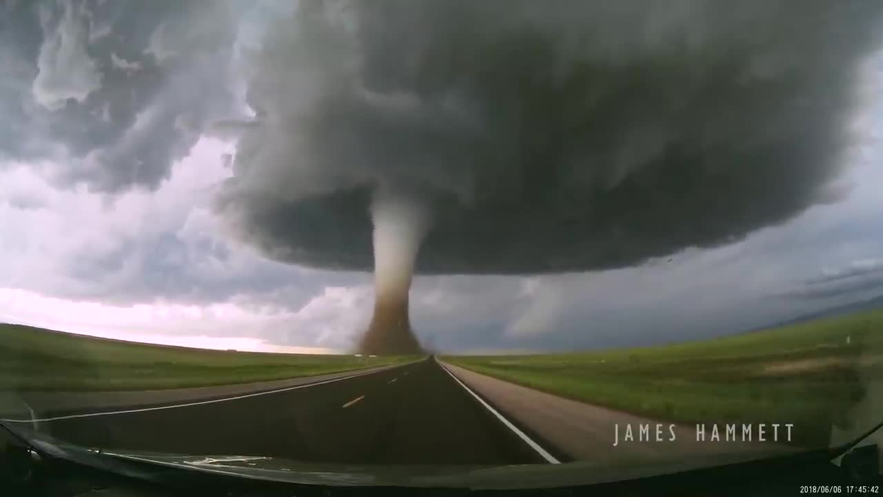 Storm chasing dashcam: Tornado crossing the highway! Laramie, Wyoming