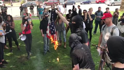 Aug 6 2017 Portland 1.2 Antifa burn flag near the freedom march group 1