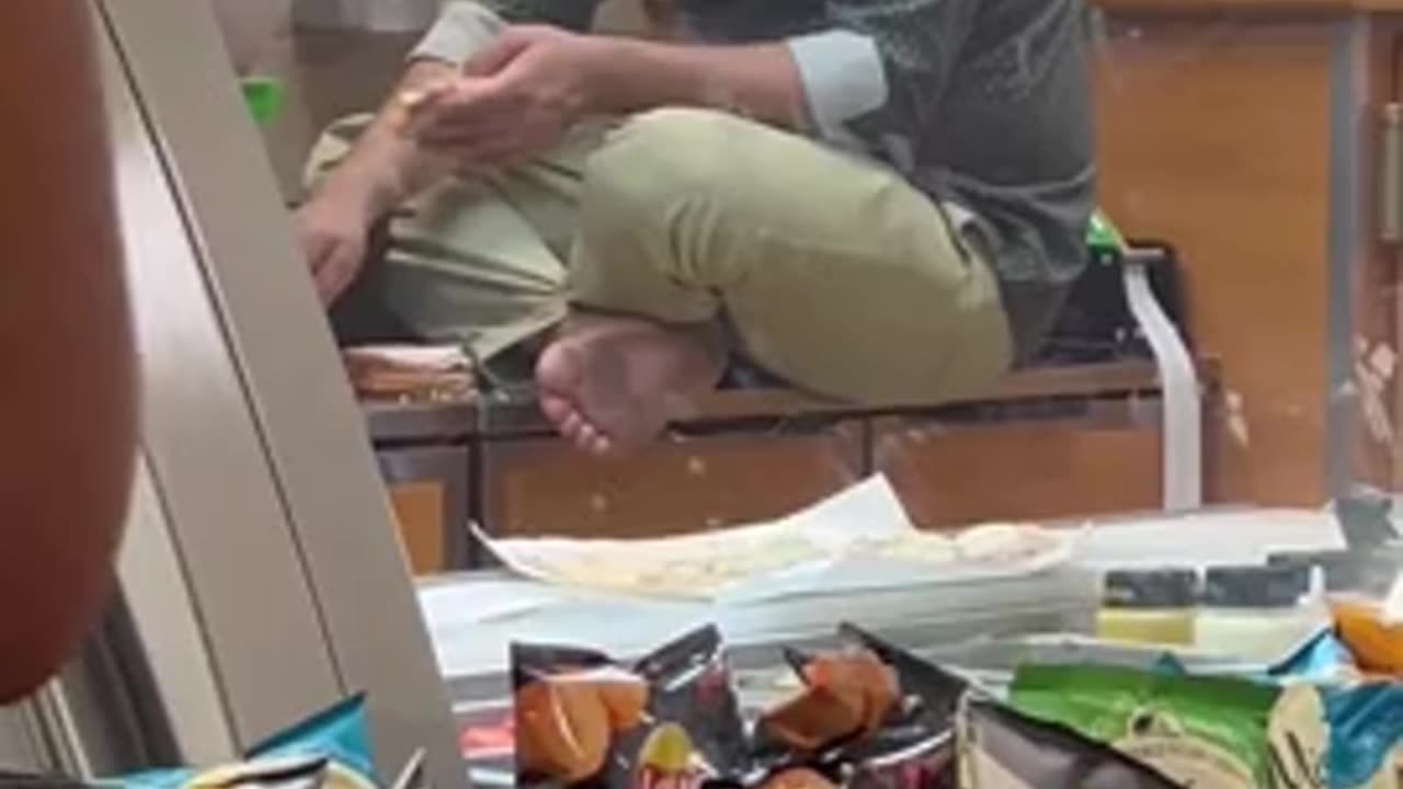 a man making a sandwich barefoot on a #Subway counter in #Chicago.