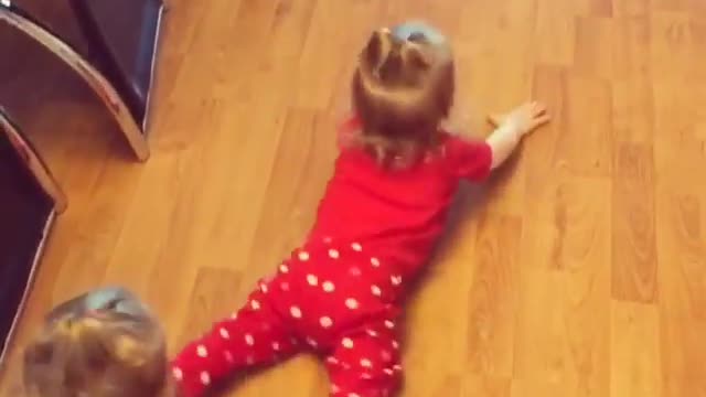 Twin baby girls mop the floors by crawling backwards