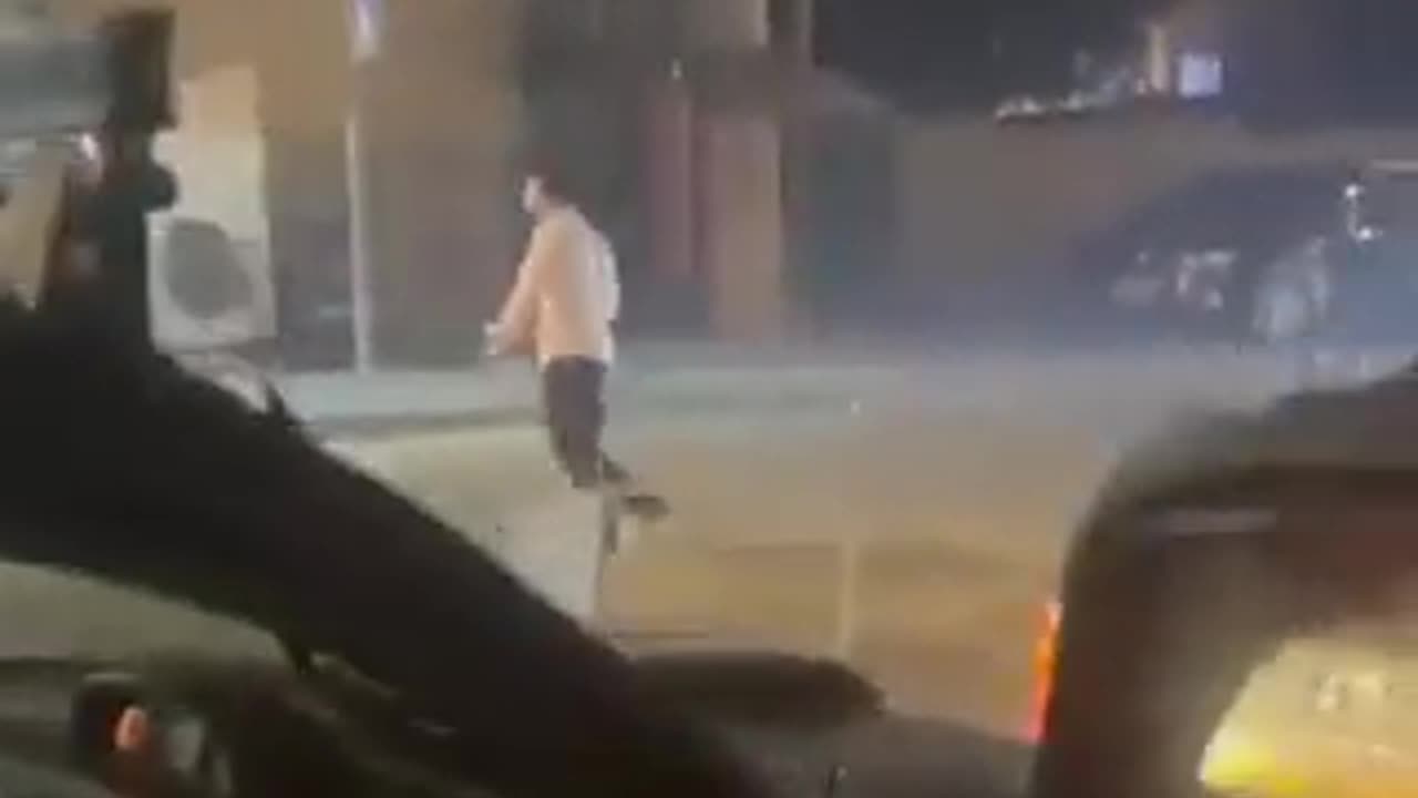 A settler fires live bullets at Palestinians during clashes that erupted in the town of Al-Tur