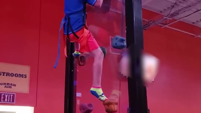 Young Boy Climbs Clear Rock Wall And Jumps Down After Reaching Top