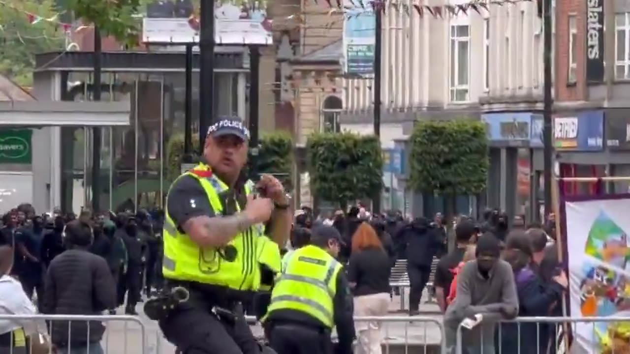 Crowds of Muslim immigrants in Bolton move threateningly towards...