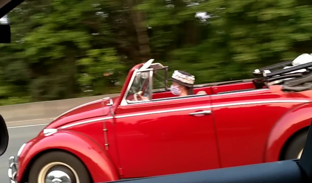 Mask wearer in a convertible at Interstate Speeds