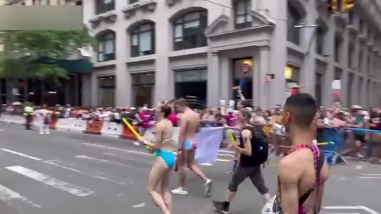 Dog mask and breasts shaking at NYC Pride. Bubbles and drag queens.