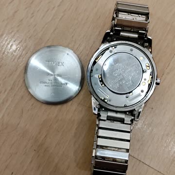 Trying To Put A Battery Cover Back On The Back Of An Analog Timex Watch, 9/11/23