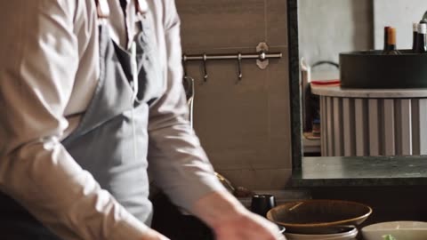 Chefs Preparing And Cooking Food In The Kitchen