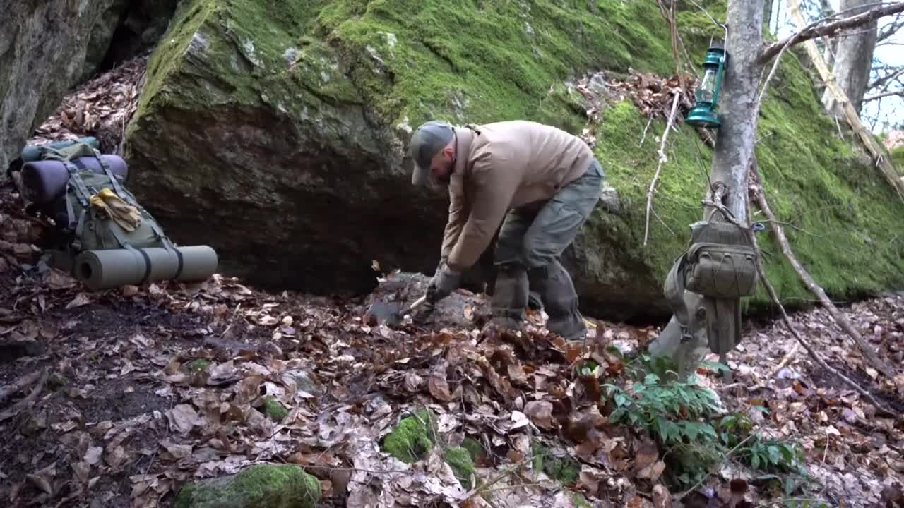 Four excavated shelter.Building underground bunker.Earth hut. primitive technology.Clay stone oven-4