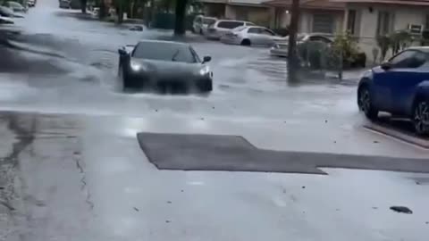 Corvett crossing the flood water