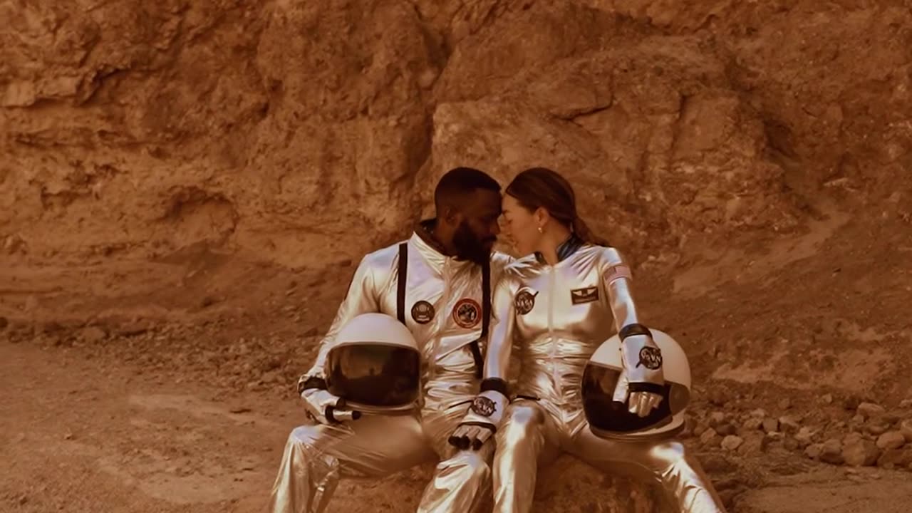 An asstronaut couple staring at each other