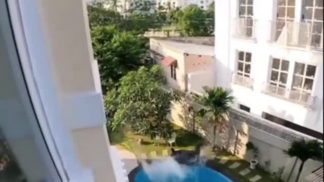 Man doing dangerous stunts when jumped from second floor to a pool