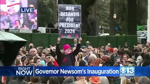 Newsom Inauguration Crowd Rips Sign Away From DeSantis Supporter