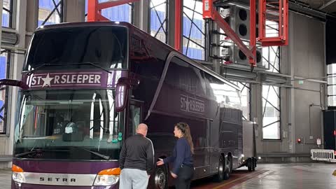 Bus and Trailer Being Turned Around by Large Lift