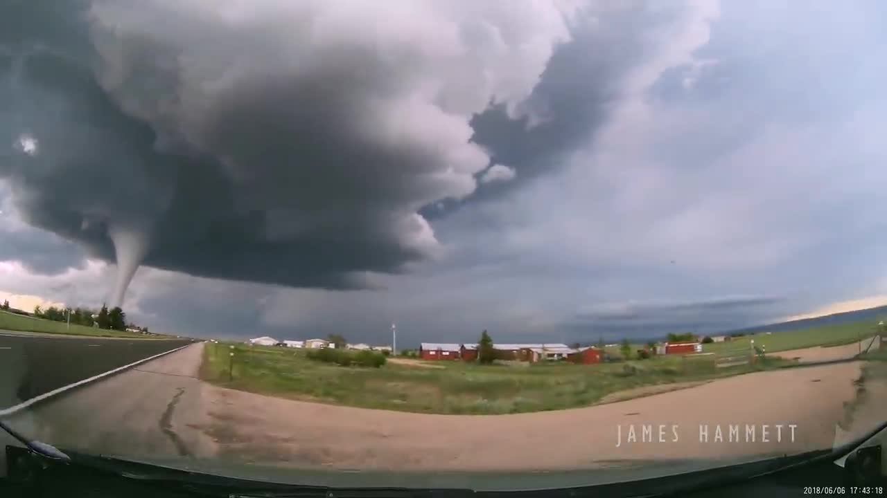 Storm chasing dashcam: Tornado crossing the highway! Laramie, Wyoming