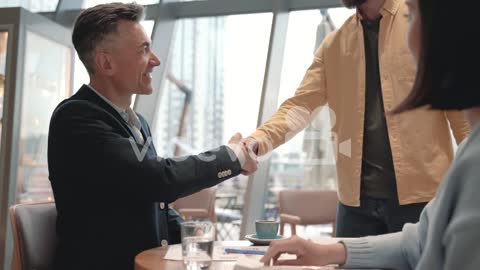 A Business Man Has A Meeting With An Unrecognizable Woman In A Cafeteria 3