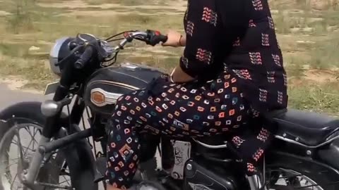 Video of girl riding a bullet bike