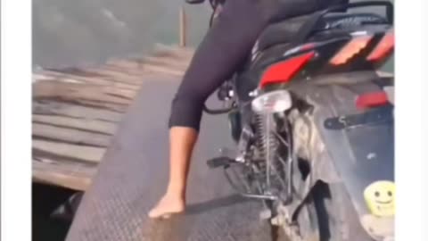 Crazy Indian boy riding bike in ocean