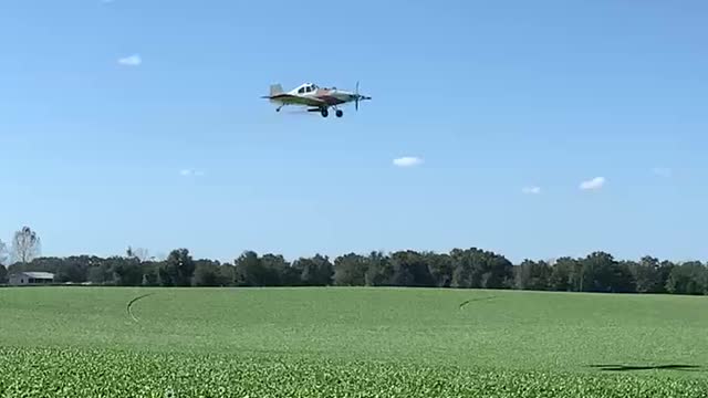 Crop duster spraying a spinach field in Florida.