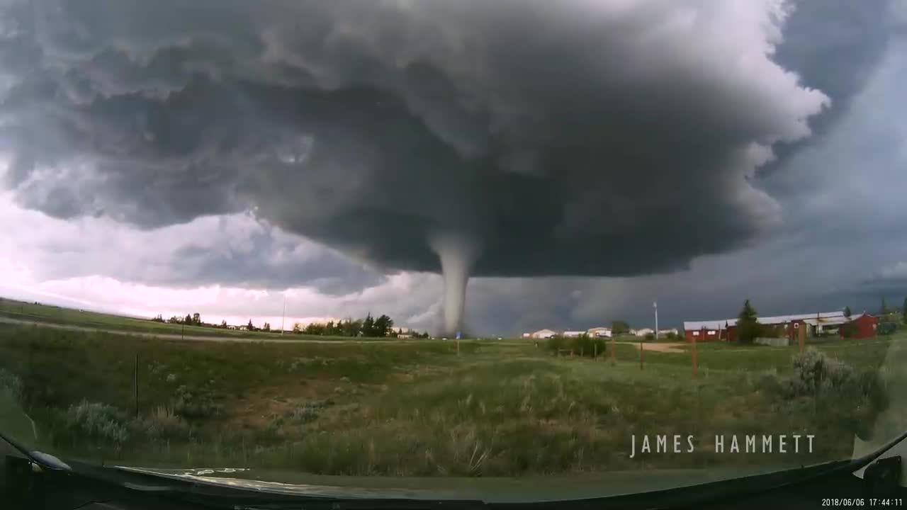 Storm chasing dashcam: Tornado crossing the highway! Laramie, Wyoming