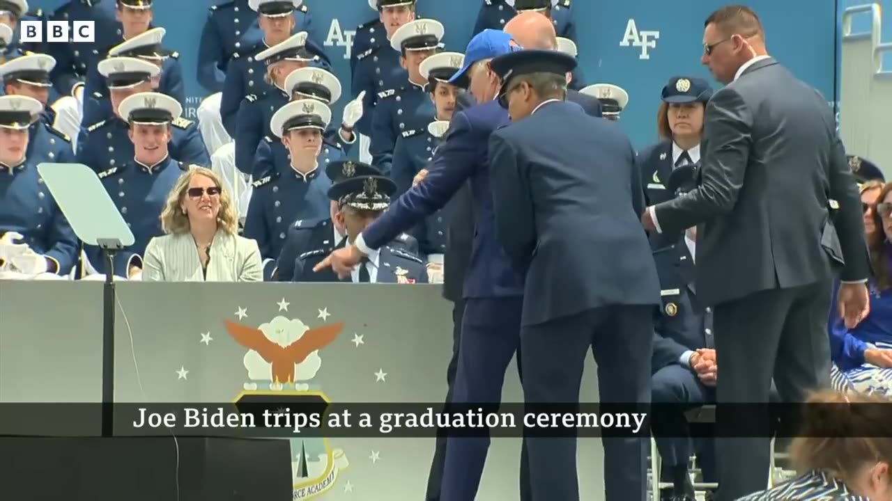 US President Biden trips and falls over at graduation event