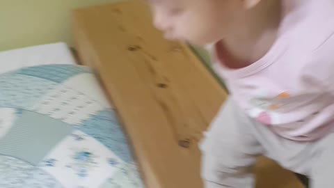 the child is playing in bed