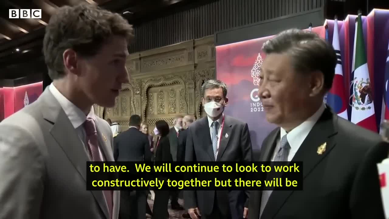 China and Canada leaders caught having tense exchange on camera - BBC News