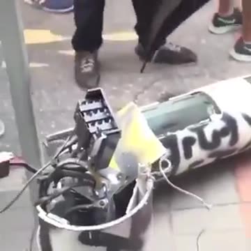 People cutting down facial recognition towers in Hong Kong