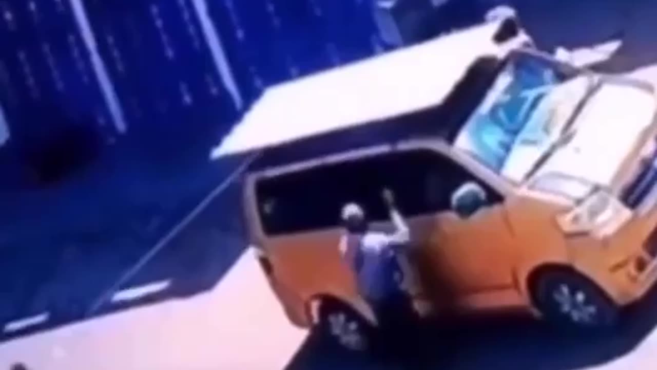 man throws rope over van to tie down load but gets a motorbike rider going past.