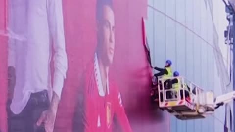 have begun taking down a mural from Old Trafford