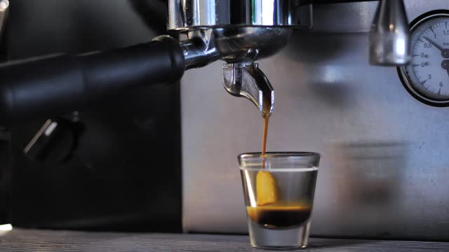 Coffee maker serving an espresso