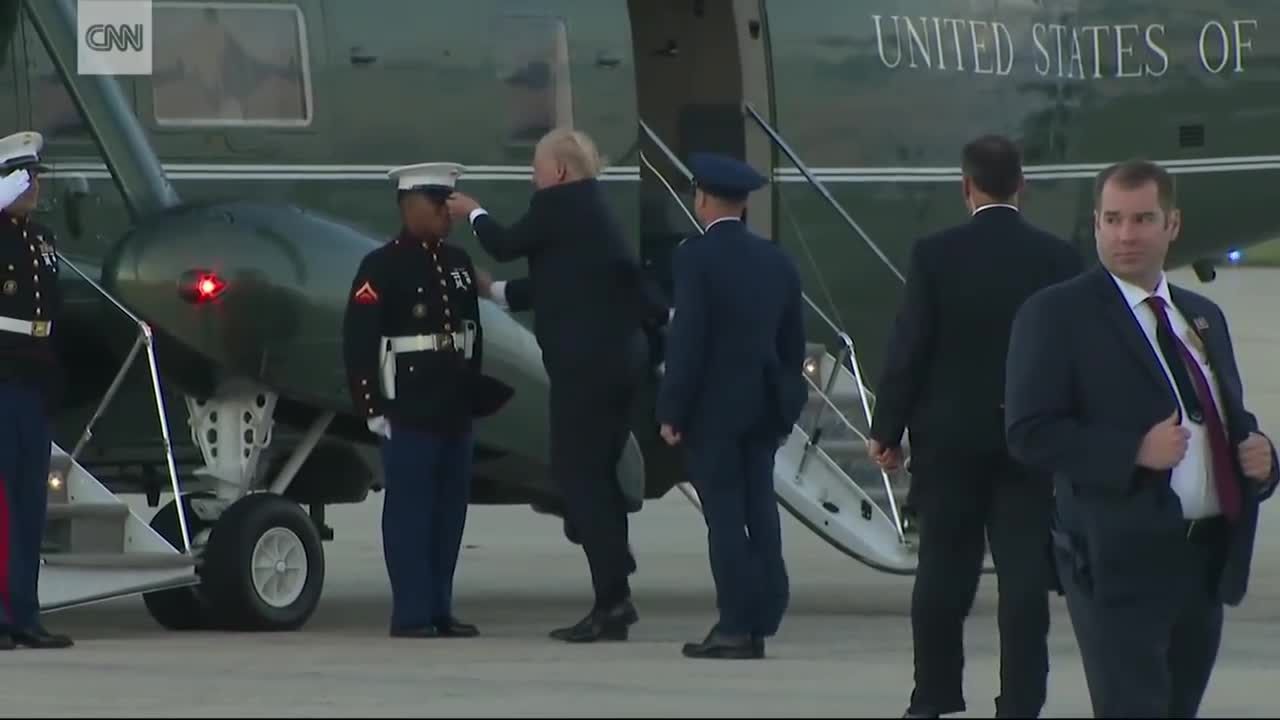 Trump stops to retrieve Marine's hat_1