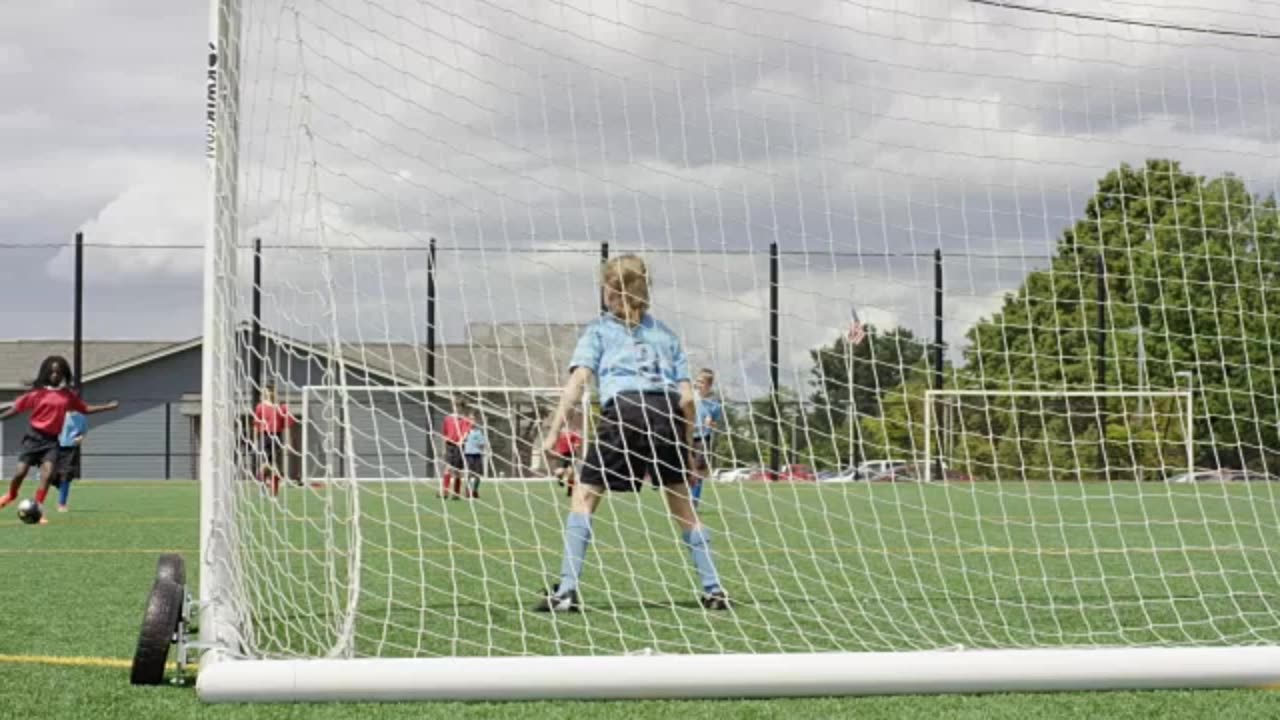 Children dribbling a soccer