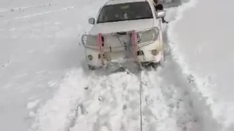 Snow in Afghanistan trying to full out the tractor