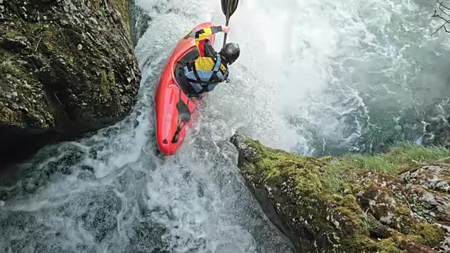 SLO MO Rider in a yellow whitewater kayak dropping a waterfall stock video