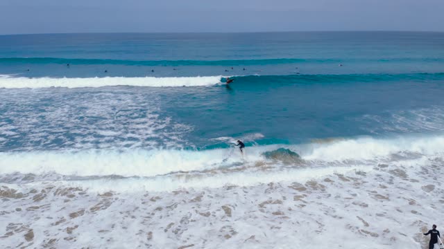 A Surfer Riding The Waves Of The Sea