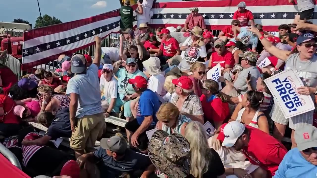 BLOODIED person carried carried away from stand following shooting at Trump rally