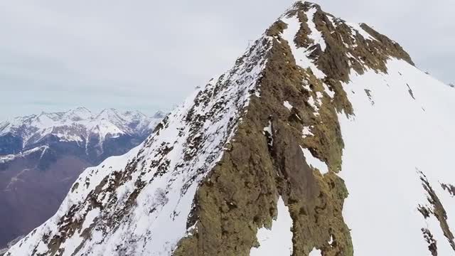 drone capturing snow topped mountains