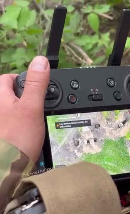 Ukrainian drone team dropping a bomb on a Russian trench